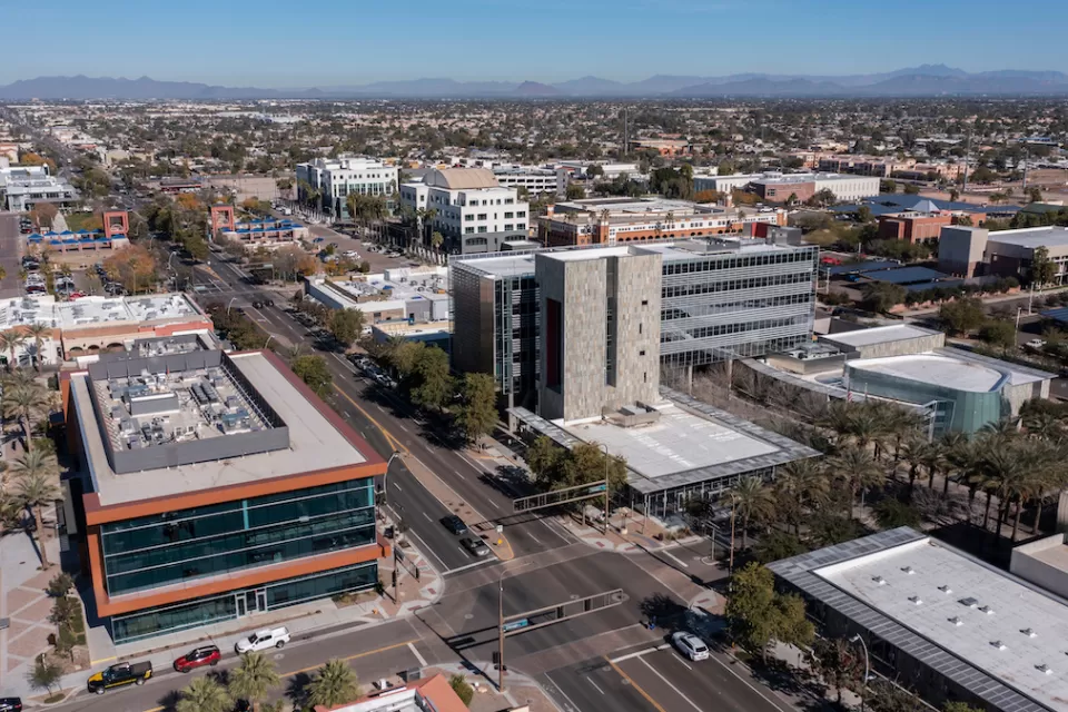Aerial view of downtown Chandler, Arizona with desert hills in background.